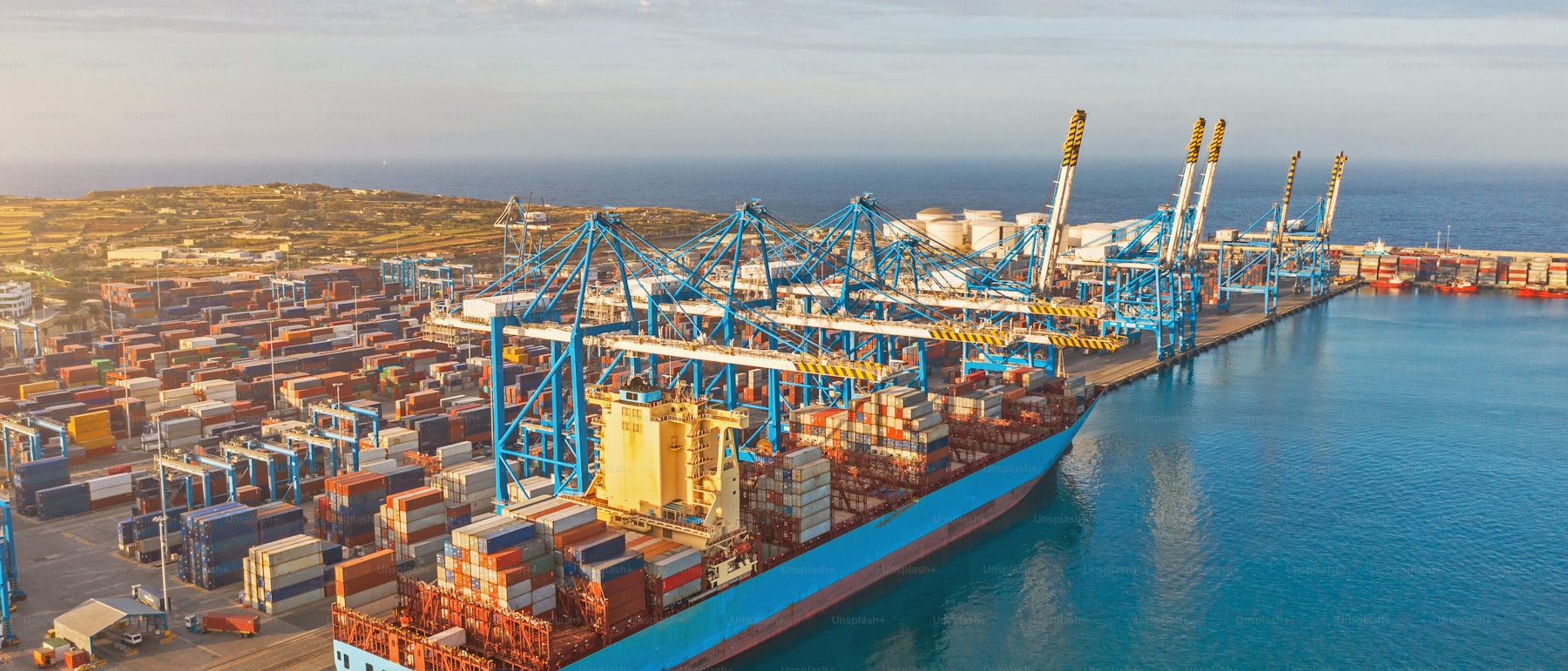 Aerial view of a cargo ship being unloaded at a port